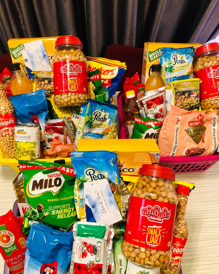 Vibrant collection of snack jars, beverages, and packaged treats in colorful baskets, perfect for any occasion.